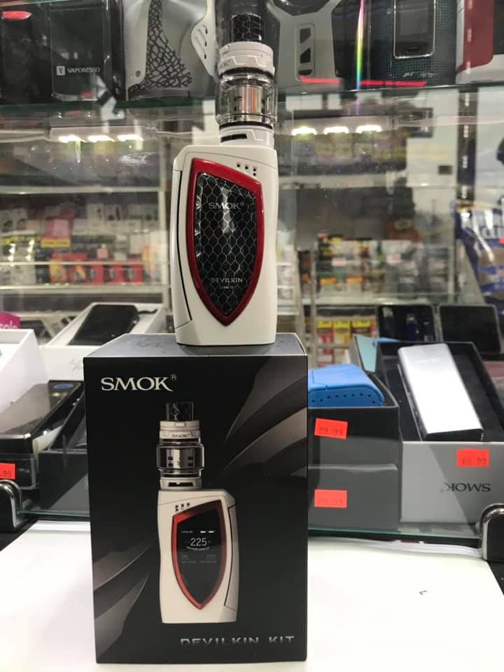 SMOK Devilkin vape kit on display. White device with red accents on box. Store shelves visible in background.